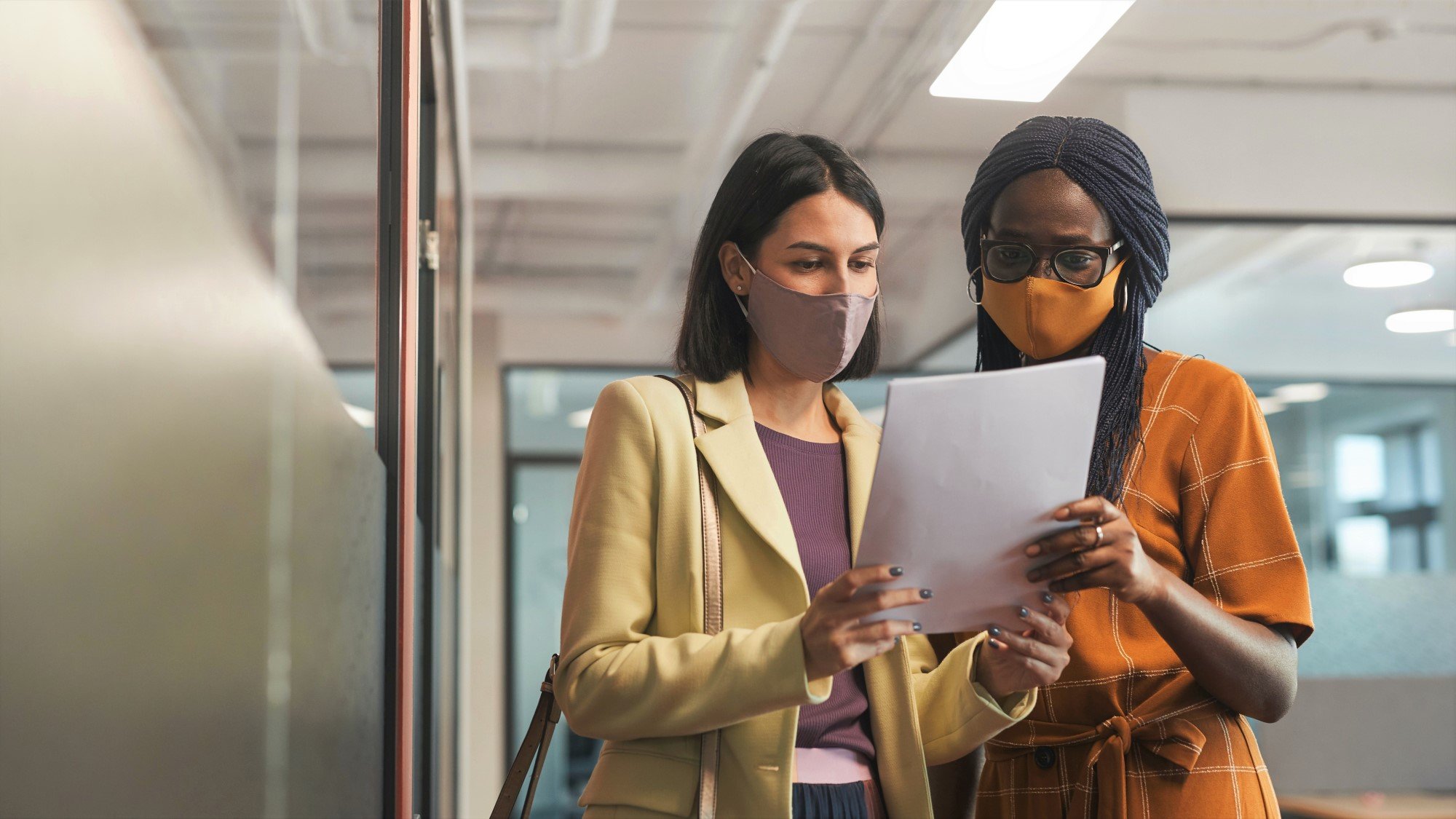 Two Woman Looking at COVID Impact on Insurance FAQ